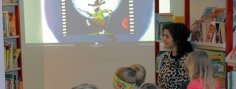 Kinder, die auf dem Boden sitzen und einen Film anschauen